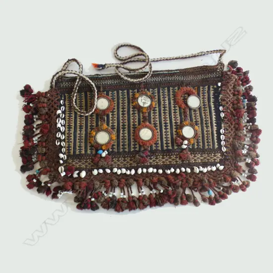 An Afghani woven back, decoarted with disc mirrors and cowrie shells. 420 x 680mm